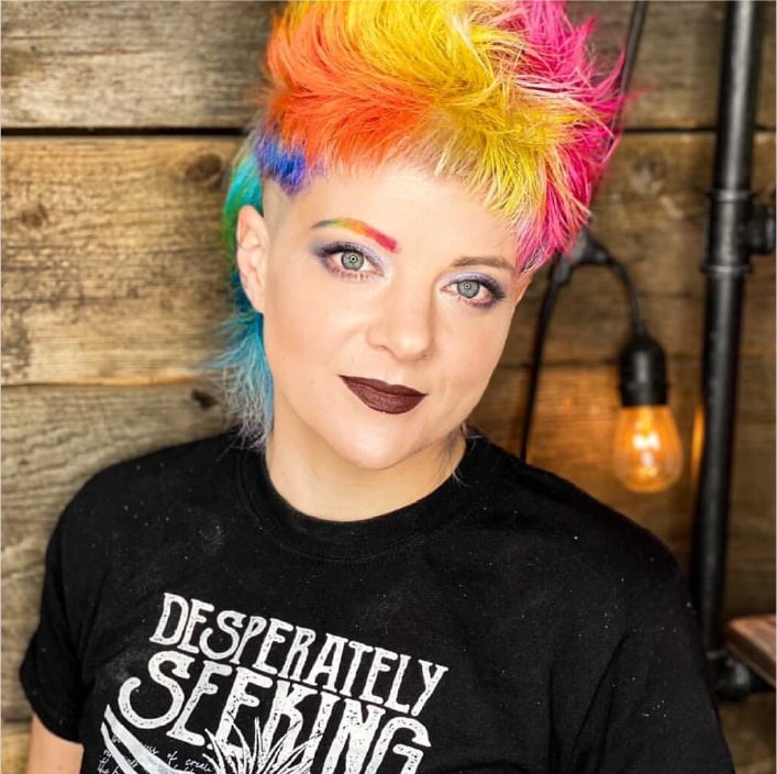 Woman with short rainbow hair in black shirt