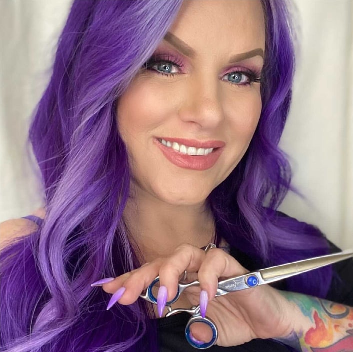 girl with purple hair holding shears