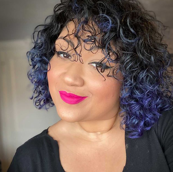 woman with blue curly hair and pink lips
