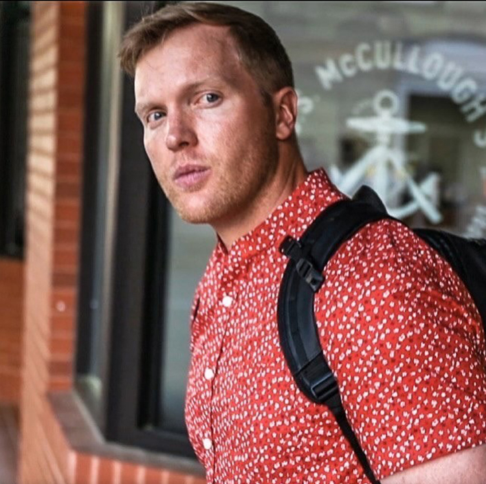 guy with red and white shirt with backpack