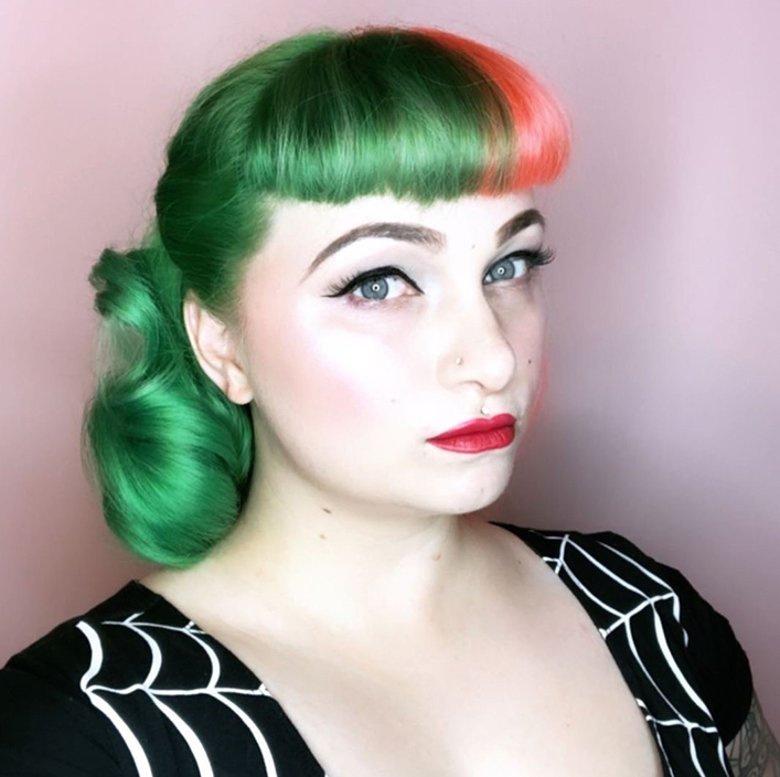 woman with green and pink hair with black and white shirt