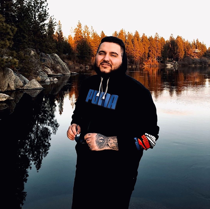 guy in front of lake with puma hoodie on